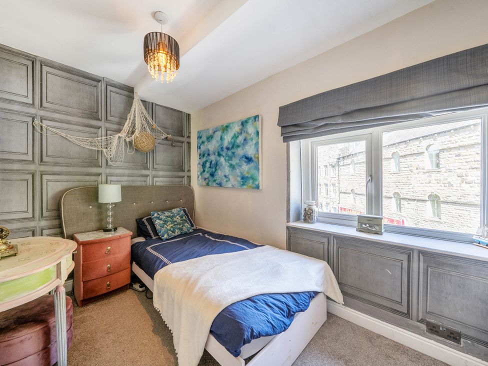 A bedroom with a bed and a nightstand at Hebden Bridge - House - Sleeps 8 - Pet Friendly, Hebden Bridge