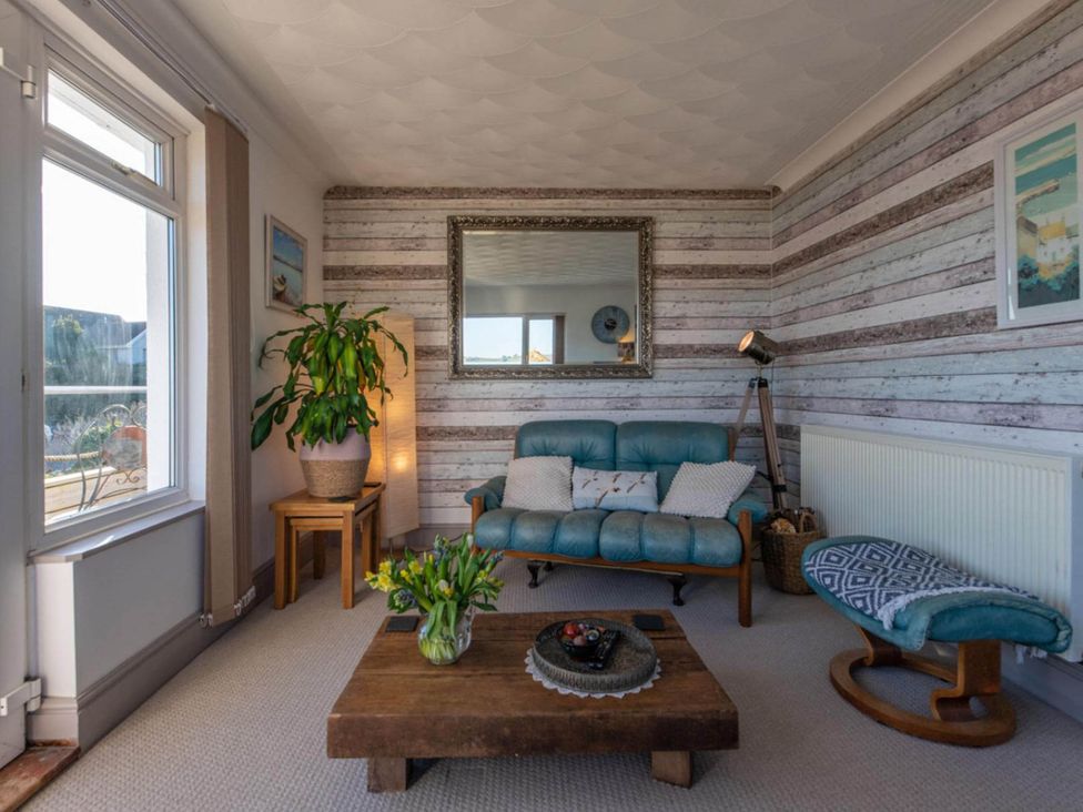 A living room with a sofa and coffee table at 1 Bed Flat - Sleeps 2 - Pets - Balcony - Parking in Looe