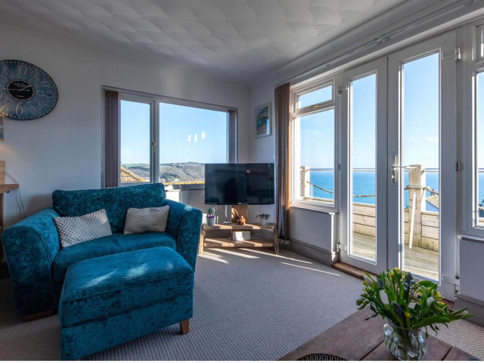 A living room with a sofa and television at 1 Bed Flat - Sleeps 2 - Pets - Balcony - Parking in Looe