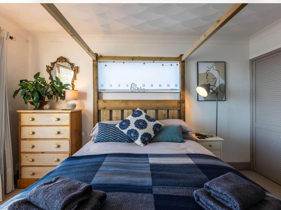 A bedroom with a bed, dresser, and plant at 1 Bed Flat - Sleeps 2 - Pets - Balcony - Parking Looe
