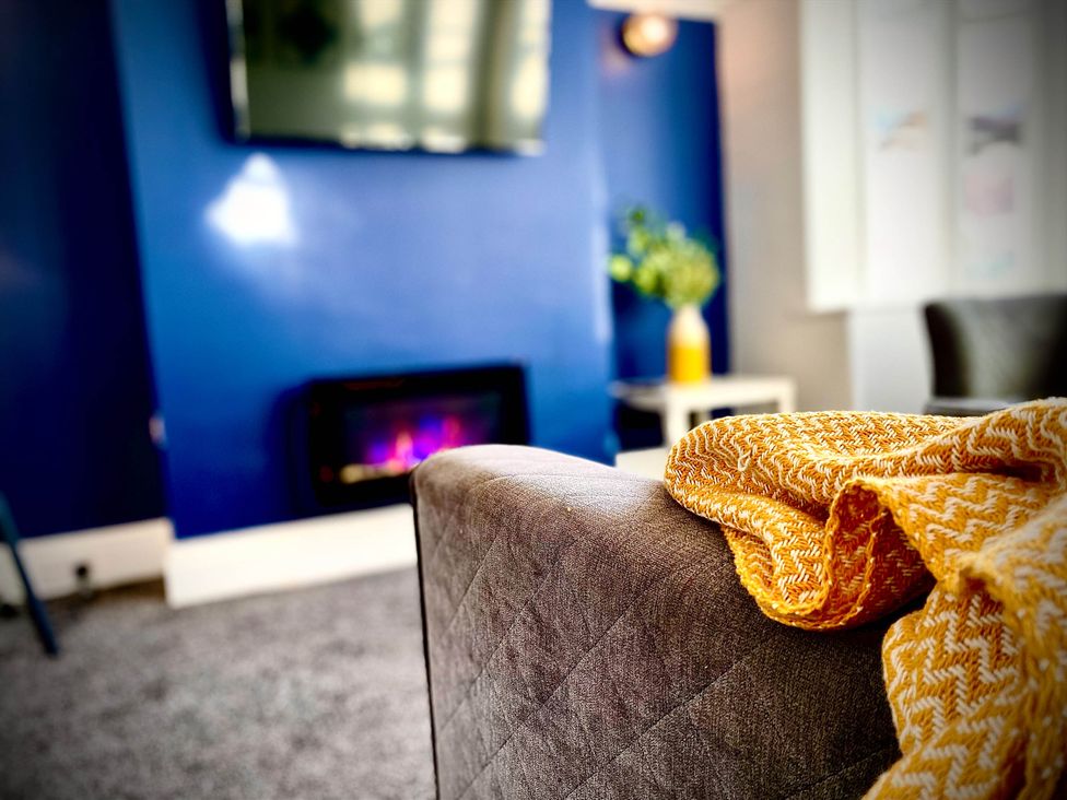 A living room with a sofa and a television at Family modern 3 bedroom hot tub house Blackpool