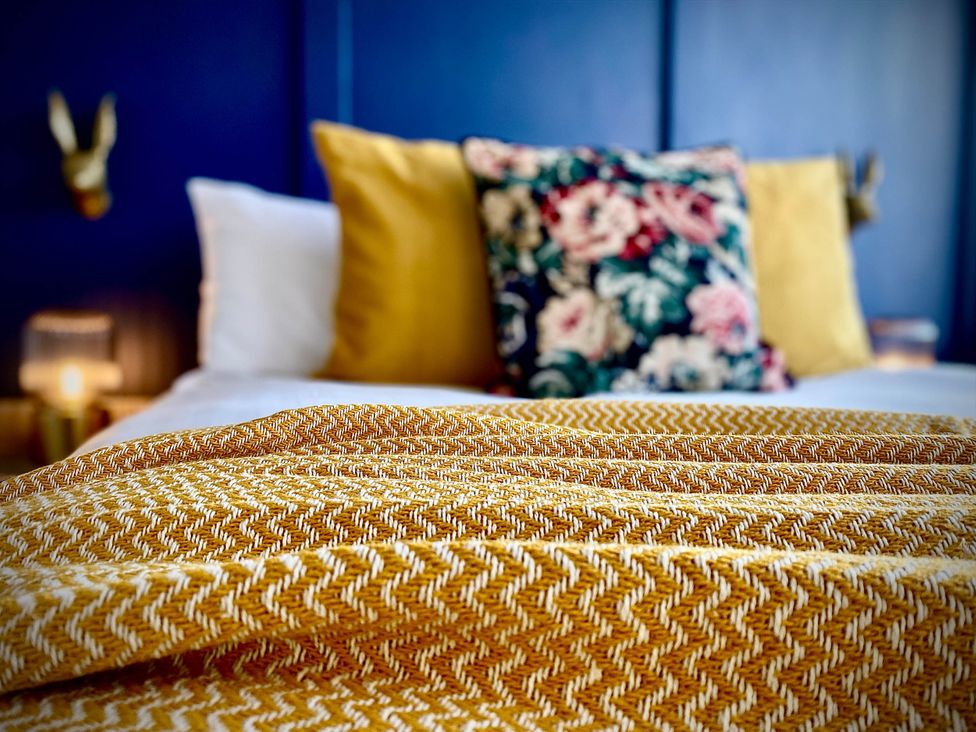 A bedroom with a bed and pillows at Family modern 3 bedroom hot tub house Blackpool