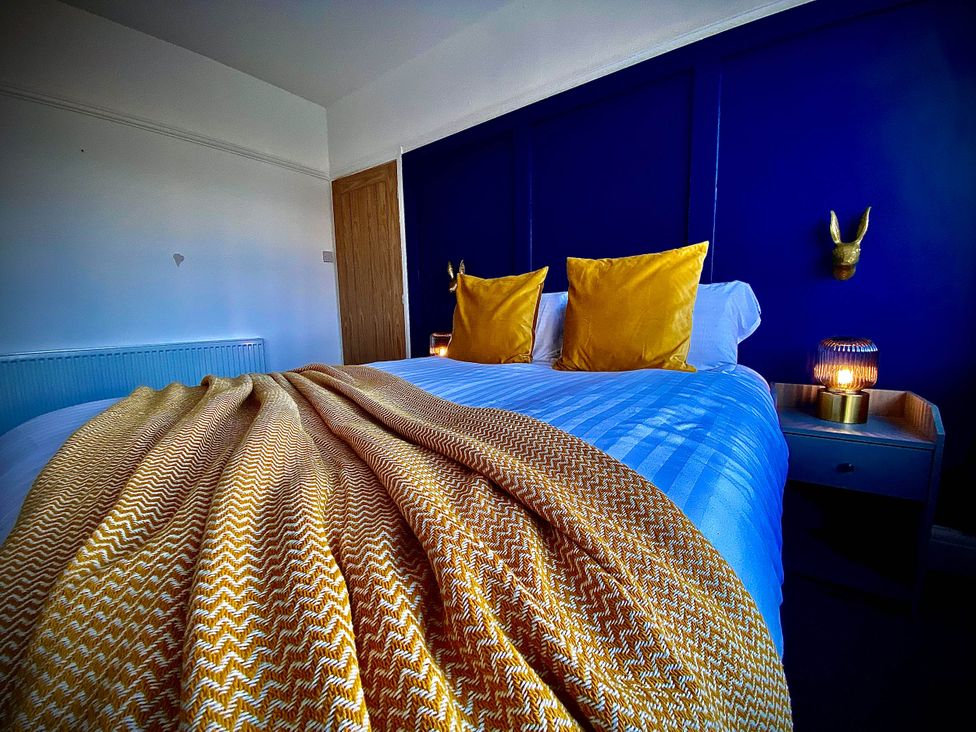 A bedroom with a bed and pillows at Family modern 3 bedroom hot tub house, Blackpool