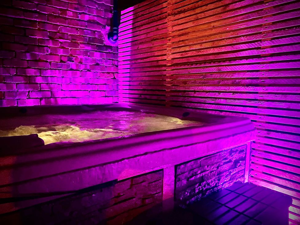 A hot tub against a wooden wall at Family modern 3 bedroom hot tub house in Blackpool