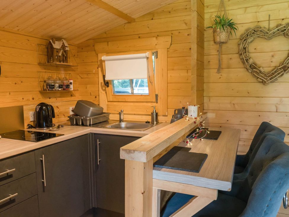 A kitchen with cabinets and a sink at Cabin for 2 - Wood Burning Hot Tub & Fire in Larkhall