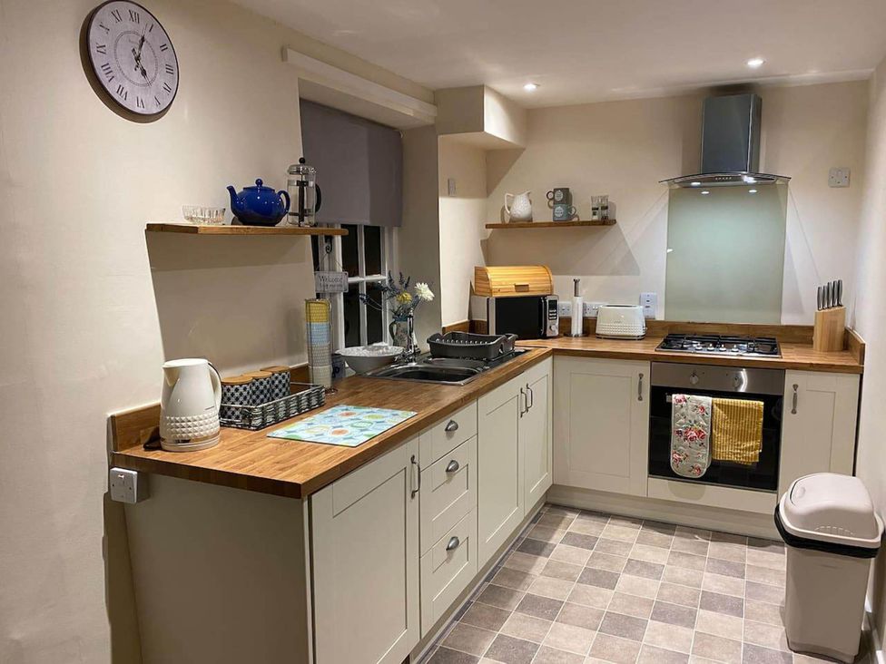 A kitchen with cabinets, sink, oven, and countertop at Apartment - Sleeps 2 - Pet friendly - Parking, Ludlow