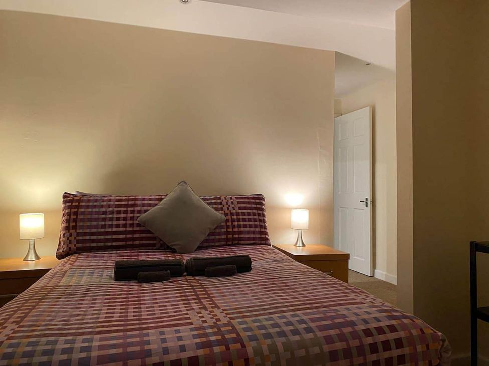 A bedroom with a bed and lamp at Apartment - Sleeps 2 - Pet friendly - Parking in Ludlow