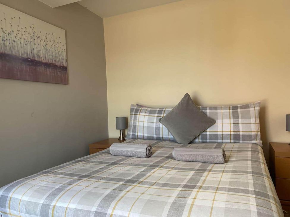 A bedroom with a bed and bedside table at Apartment - Sleeps 2 - Pet friendly - Parking in Ludlow