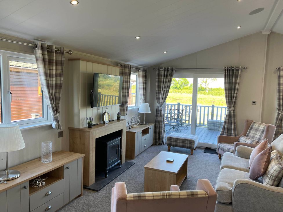 A living room with a television and seating area at Yorkshire View Lodge in Wilberfoss
