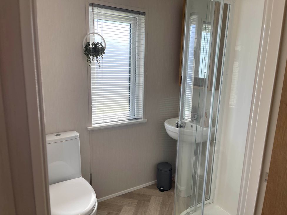 A bathroom with a toilet, shower, and sink at Yorkshire view lodge Wilberfoss
