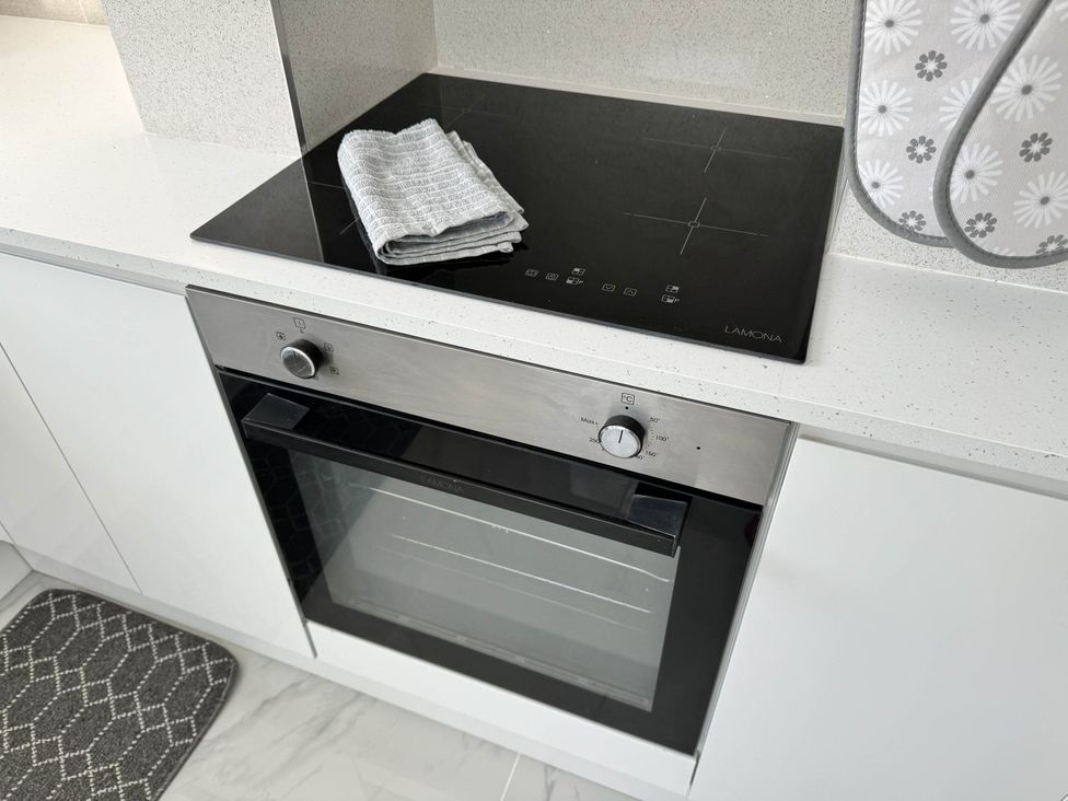 An oven and cooktop with a towel in the kitchen at Modern 3-Bed Hideaway Near Westgate With Parking Canterbury