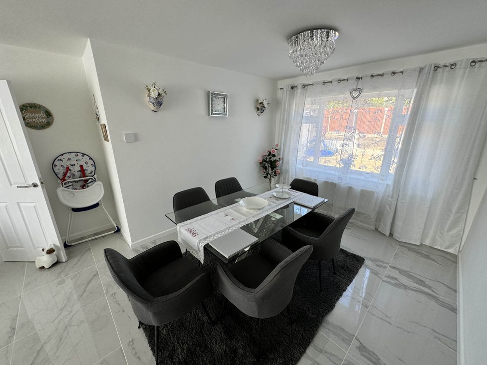 A dining area with a glass table and chairs at Modern 3-Bed Hideaway Near Westgate With Parking, Canterbury