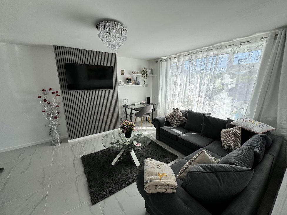 A living room with a sofa and coffee table at Modern 3-Bed Hideaway Near Westgate With Parking in Canterbury