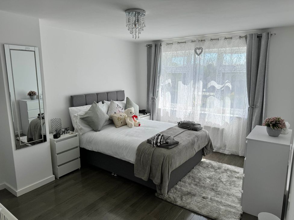 A bedroom with a bed and dressing table at Modern 3-Bed Hideaway Near Westgate With Parking in Canterbury