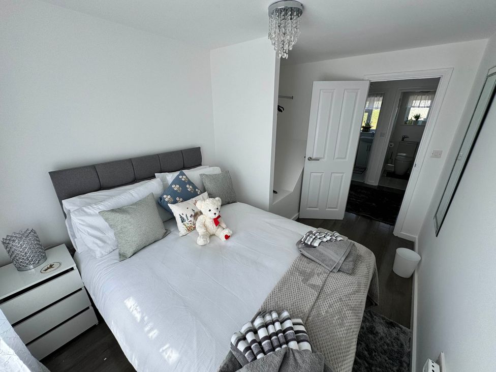 A bedroom with a bed and a nightstand at Modern 3-Bed Hideaway Near Westgate With Parking, Canterbury