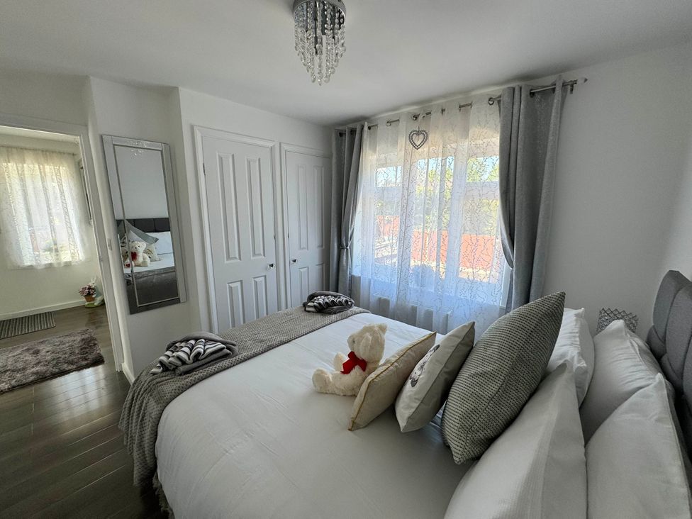 A bedroom with a bed and a teddy bear at Modern 3-Bed Hideaway Near Westgate With Parking, Canterbury