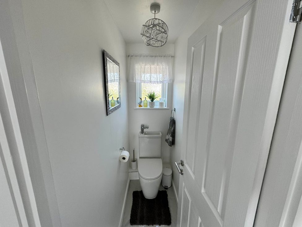 A bathroom with a toilet and mirror at Modern 3-Bed Hideaway Near Westgate With Parking, Canterbury