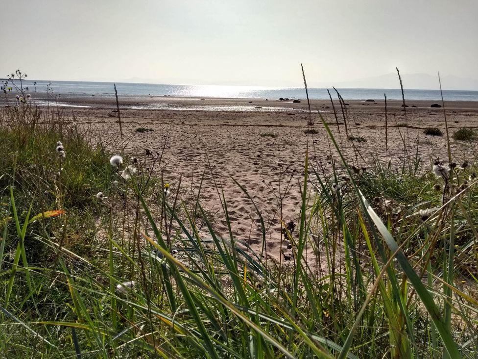 A beach scene with sand and grass at Cleeves Cabins 2, Arran Luxury Lodge with hot tub St. John's Town Of Dalry