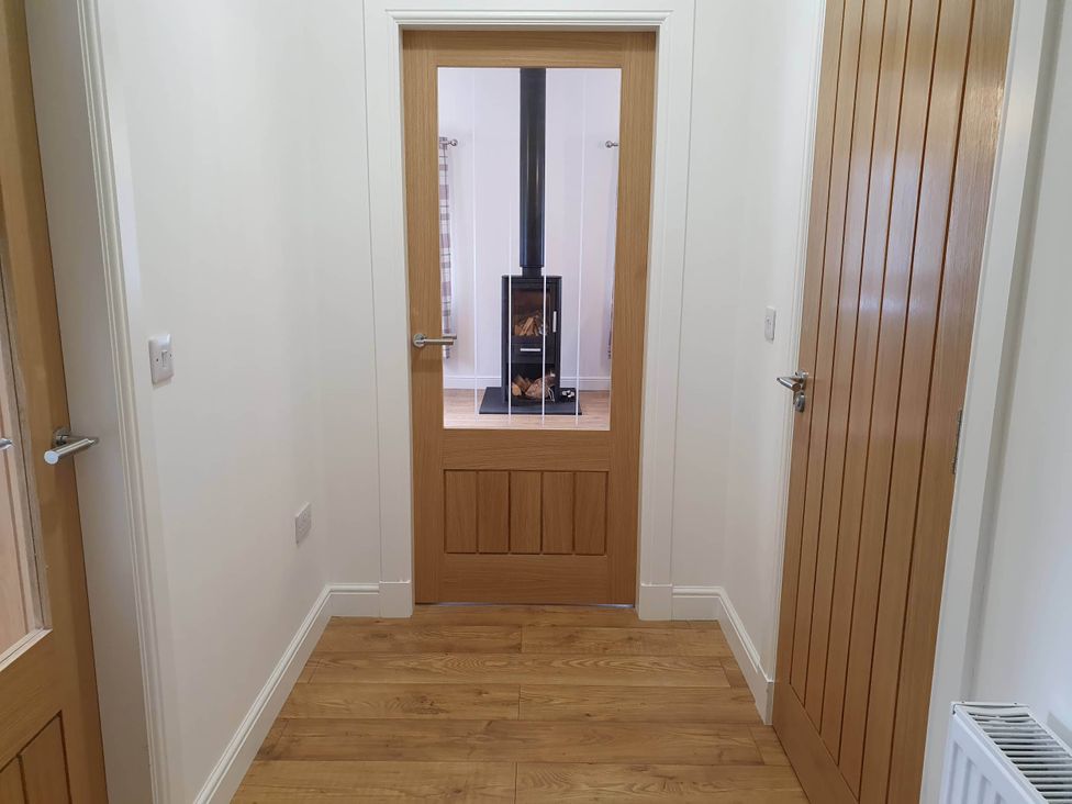 A hallway with a view of a fireplace at 2-Bed Barn, Hot Tub & Pet Friendly near Muirkirk