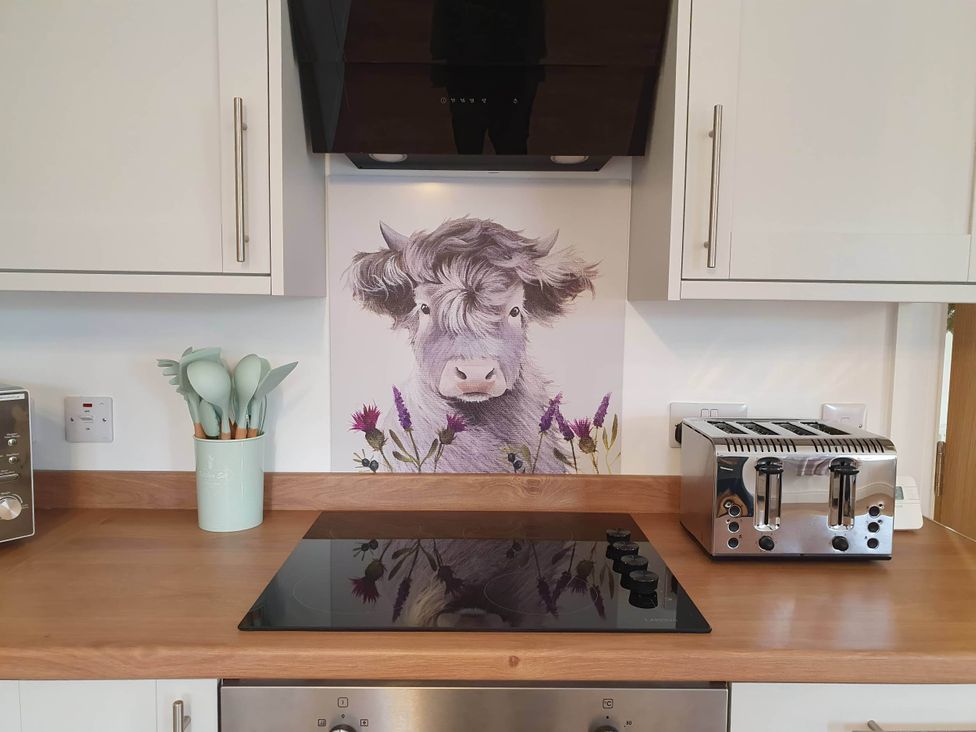 A kitchen with a stove and toaster at 2-Bed Barn, Hot Tub & Pet Friendly near Muirkirk