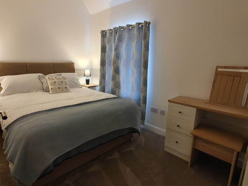 A bedroom with a bed and desk at 2-Bed Barn, Hot Tub & Pet Friendly near Muirkirk