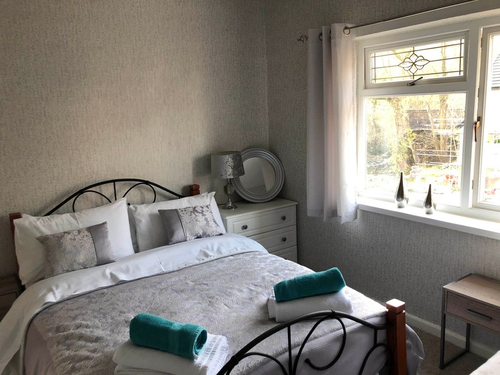 A bedroom with a bed and a window at 3 Bed House - Sleeps 6 - Parking - Garden - WIfi in Glynneath