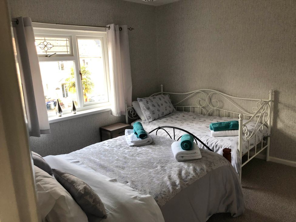 A bedroom with two beds and towels on them at 3 Bed House - Sleeps 6 - Parking - Garden - Wifi Glynneath