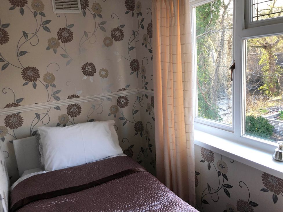 A bedroom with a bed and window at 3 Bed House - Sleeps 6 - Parking - Garden - Wifi Glynneath