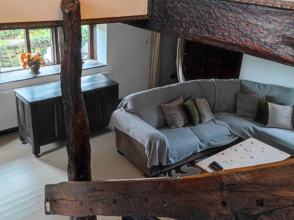 A living room with a sofa and coffee table at 3 bedroom- Sleeps 6-Greave Farm Todmorden Cottage in Todmorden