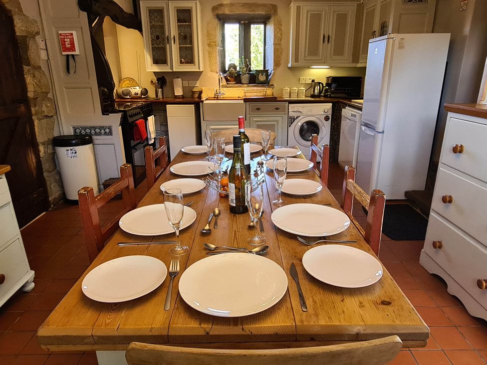 A kitchen with a dining table set for a meal at 3 bedroom Sleeps 6 Greave Farm Todmorden Cottage