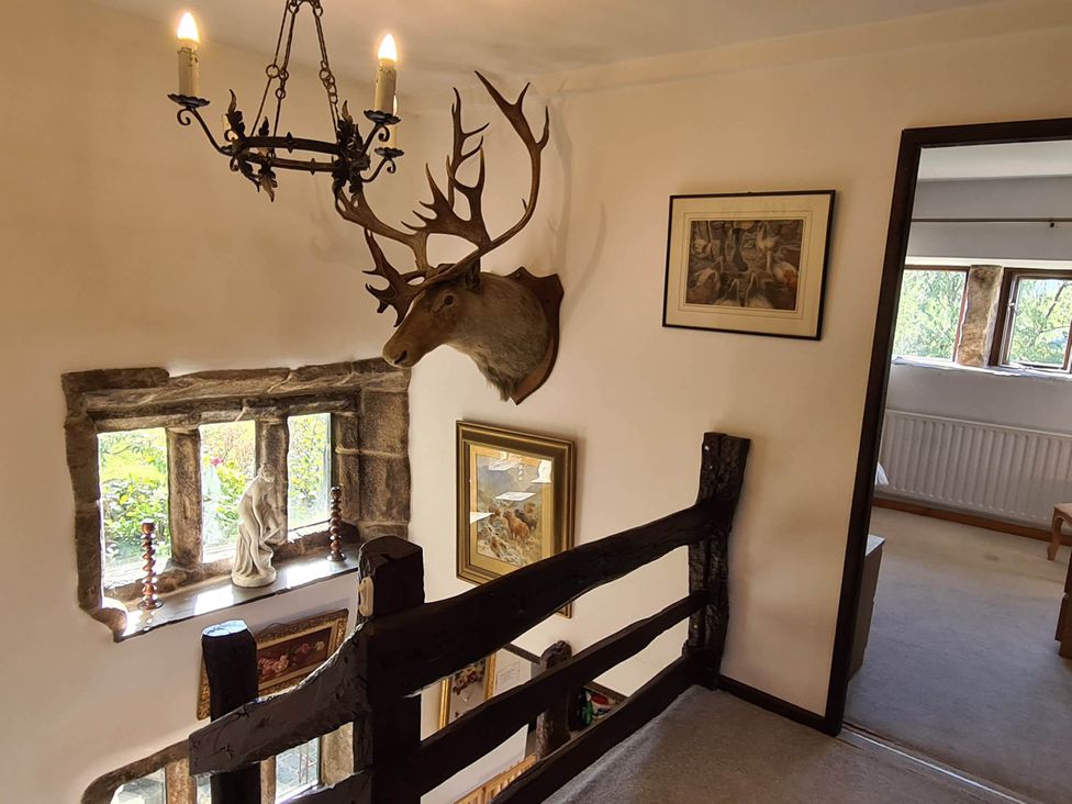 A hallway with a deer head mounted on the wall at 3 bedroom- Sleeps 6-Greave Farm Todmorden Cottage, Todmorden