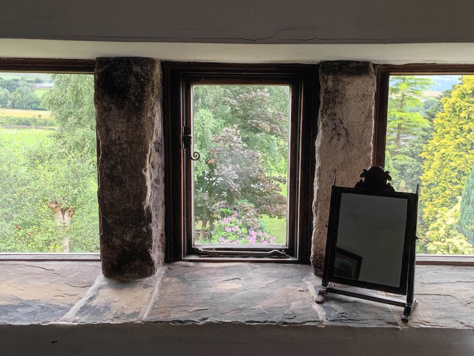 A window with a view and a mirror at 3 bedroom- Sleeps 6-Greave Farm Todmorden Cottage in Todmorden