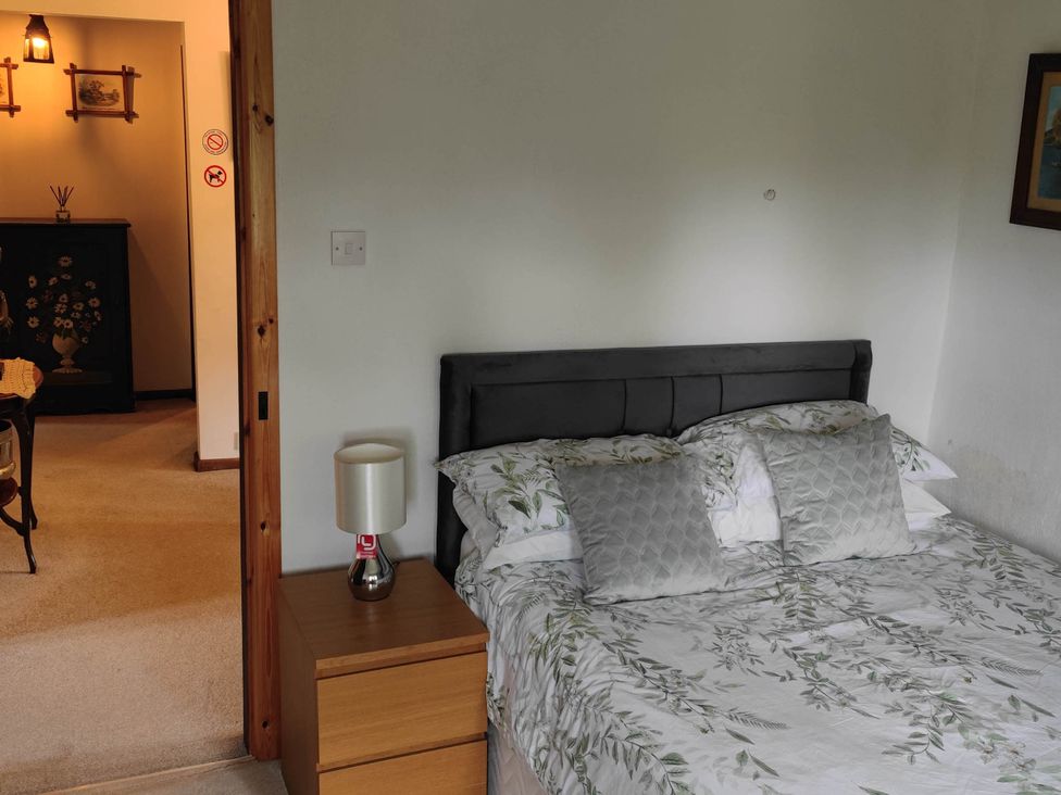 A bedroom with a bed and bedside table at 3 bedroom- Sleeps 6-Greave Farm Todmorden Cottage