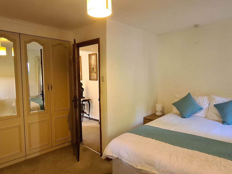 A bedroom with a bed and wardrobe at 3 bedroom- Sleeps 6-Greave Farm Todmorden Cottage in Todmorden
