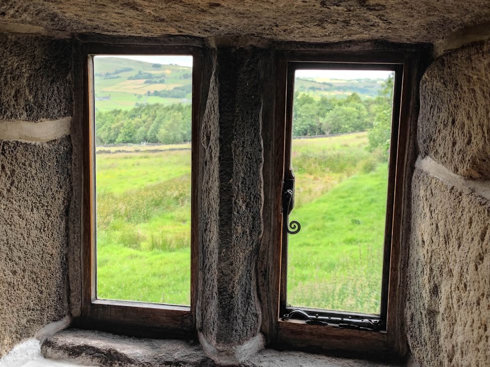 A view from two windows overlooking green fields at 3 bedroom- Sleeps 6-Greave Farm Todmorden Cottage Todmorden