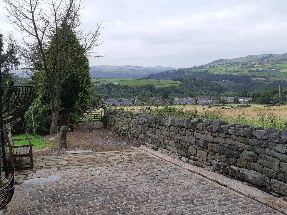 A pathway with a stone wall and trees at 3 bedroom- Sleeps 6-Greave Farm Todmorden Cottage Todmorden