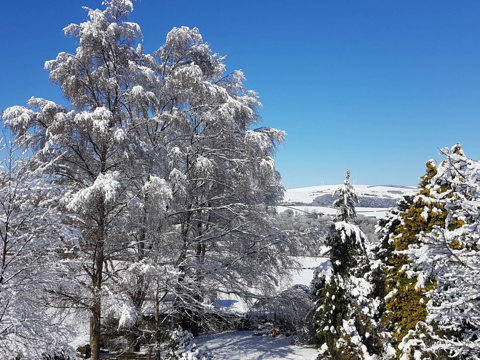 A snowy landscape with trees and hills at 3 bedroom- Sleeps 6-Greave Farm Todmorden Cottage Todmorden