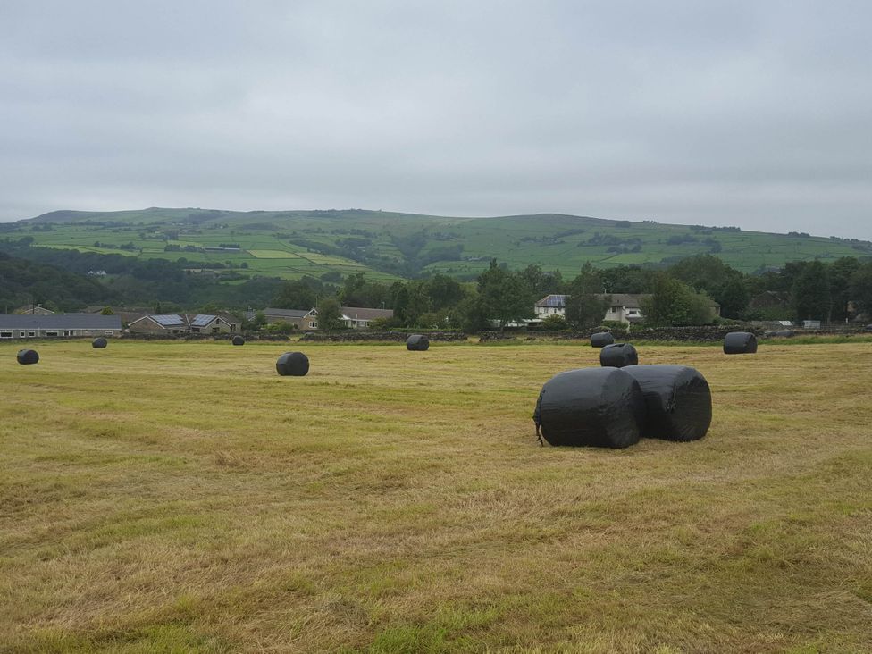 A field with hay bales and hills at 3 bedroom- Sleeps 6-Greave Farm Todmorden Cottage Todmorden