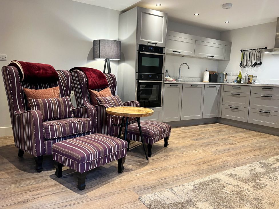 A kitchen with two armchairs and an ottoman at Cottage - Sleeps 2 - Garden in Coleford