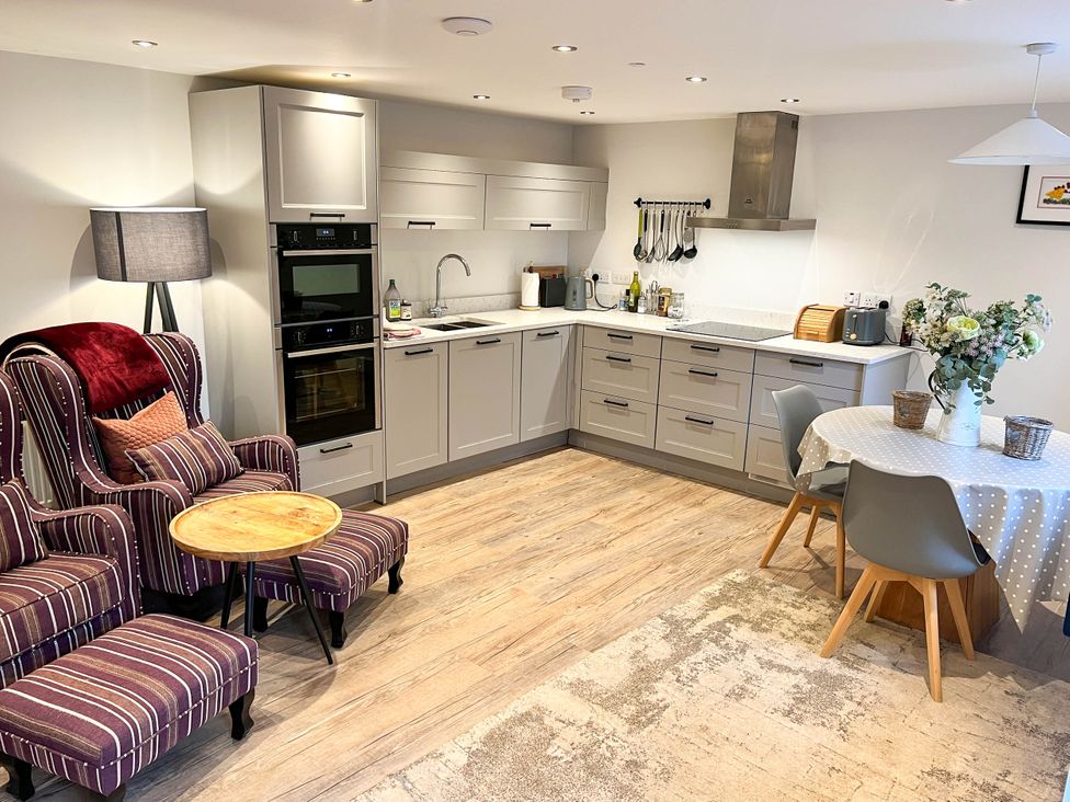 A kitchen with a table and chairs at Cottage - Sleeps 2 - Garden in Coleford