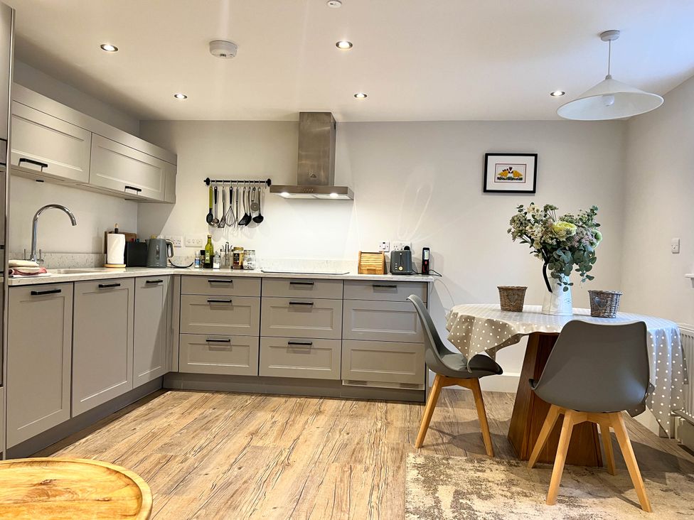 A kitchen with sink and table at Cottage - Sleeps 2 - Garden in Coleford