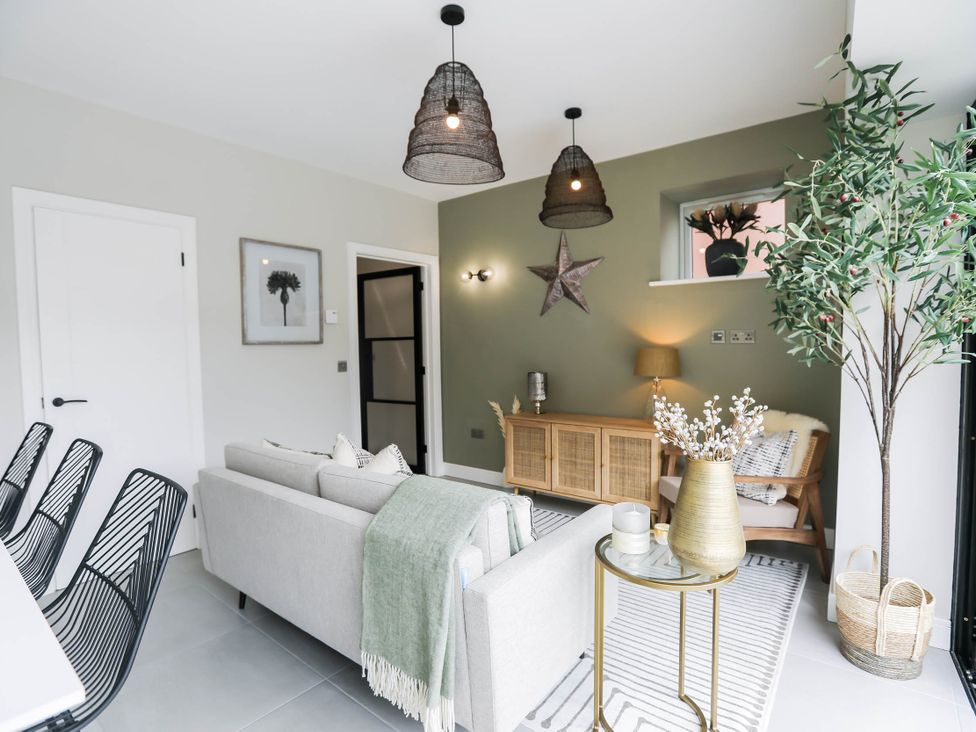 A living room with a sofa and coffee table at Luxury 2 Bed Home w/ Spa-like Ensuites & Patio in Hereford