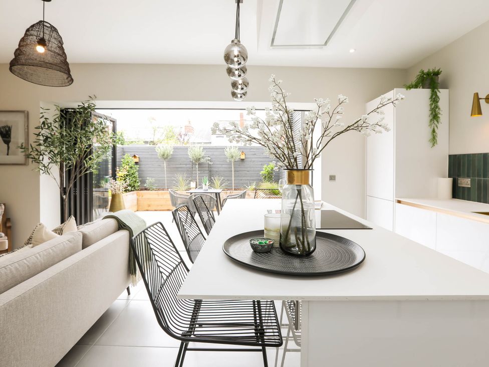 A kitchen with a dining table and chairs at Luxury 2 Bed Home w/ Spa-like Ensuites & Patio in Hereford