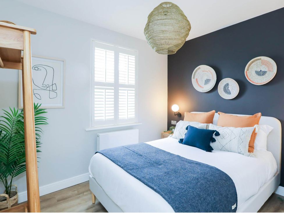 A bedroom with a bed and plant at Luxury 2 Bed Home w/ Spa-like Ensuites & Patio in Hereford