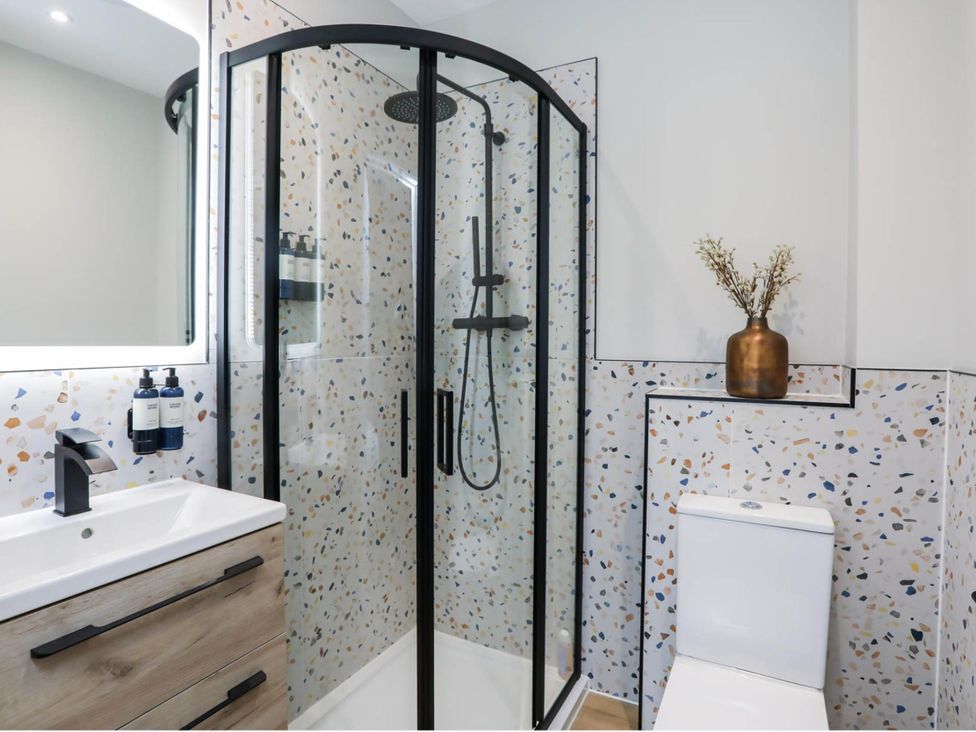 A bathroom with a shower, sink, and toilet at Luxury 2 Bed Home w/ Spa-like Ensuites & Patio Hereford
