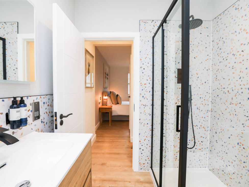 A bathroom with a shower and sink at Luxury 2 Bed Home w/ Spa-like Ensuites & Patio Hereford