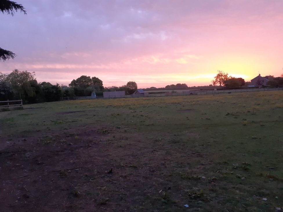 A field during sunset at Glamping at the Retreat Wiltshire is rural bliss Christian Malford