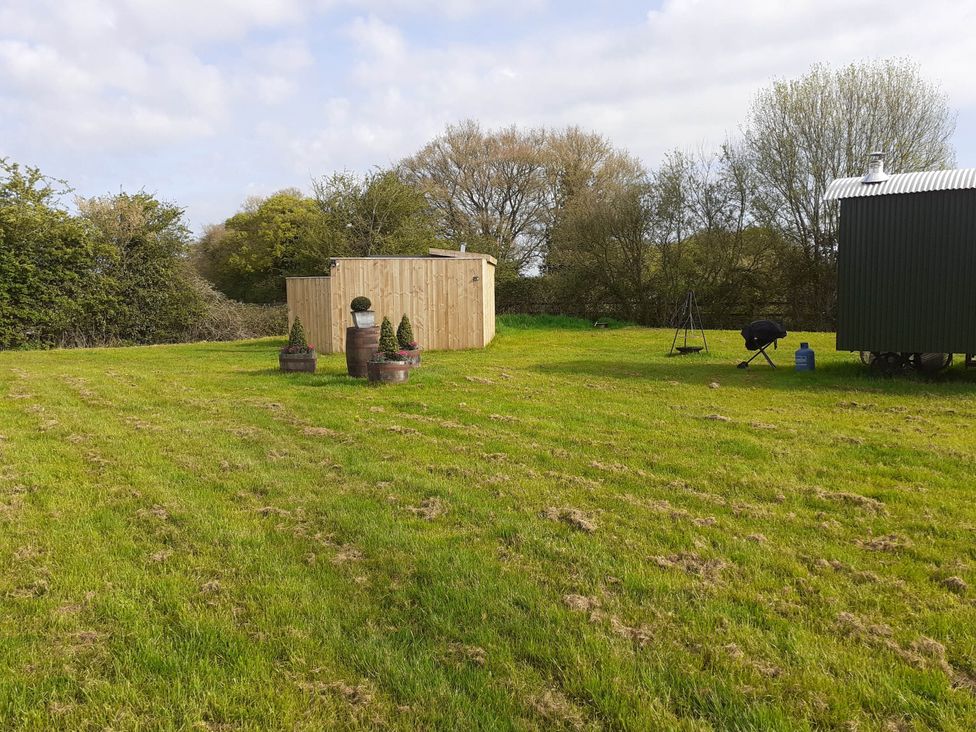 A garden with a shed and plant pots at Glamping at the Retreat Wiltshire is rural bliss, Christian Malford