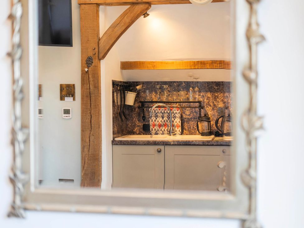 A kitchen with cabinets and a sink visible at Bramble Bank 'CartShed'-1 Bed Cottage-Sleeps 2 Henley-On-Thames