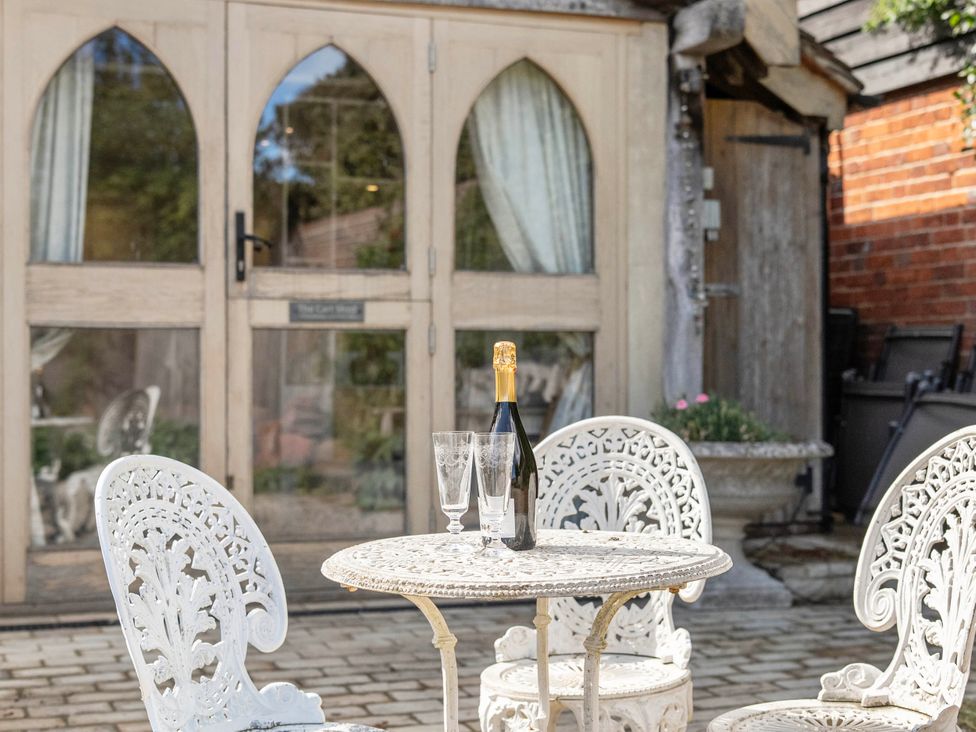 An outdoor seating area with a table and chairs at Bramble Bank 'CartShed'-1 Bed Cottage-Sleeps 2 Henley-On-Thames